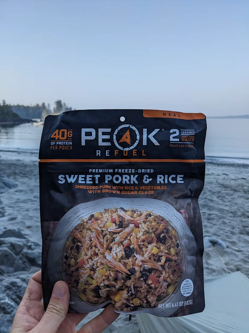 Enjoying Peak Refuel Sweet Pork and Rice on the beach.