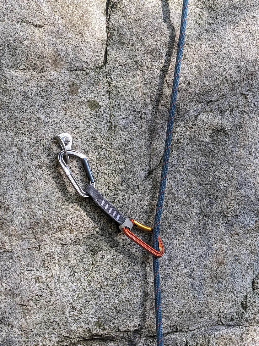 Petzl Spirit Express quickdraw clipped in to a hanger and the rope
